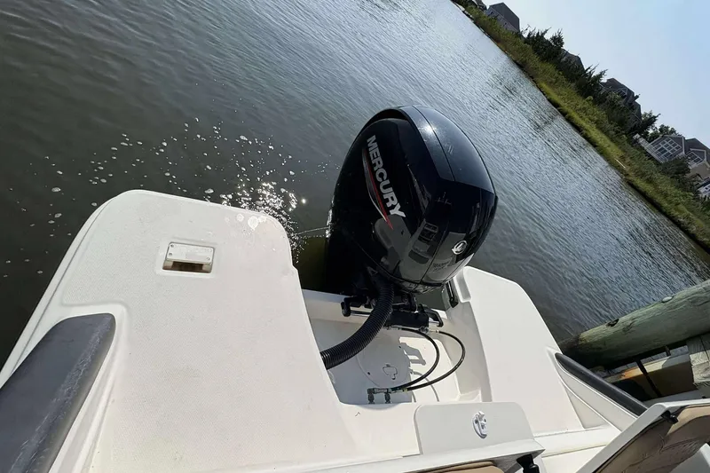 Slide: The Image of 2022 Bayliner Trophy T20CC with Mercury outboard motor on a calm waterway. - 18