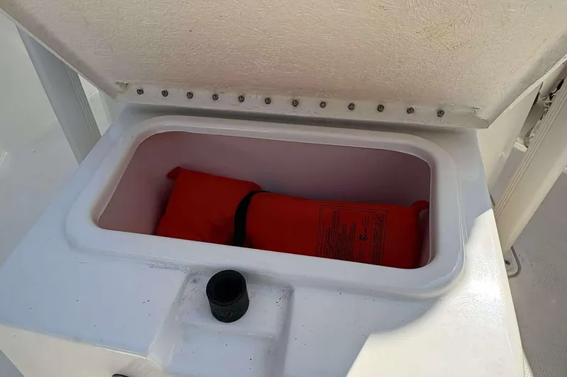Slide: The Image of Storage compartment with life jacket on 2022 Bayliner Trophy T20CC boat. - 21