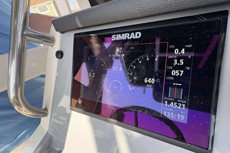 Slide: The Image of Simrad display on 2022 Bayliner Trophy T20CC showing navigation and engine data. - 23