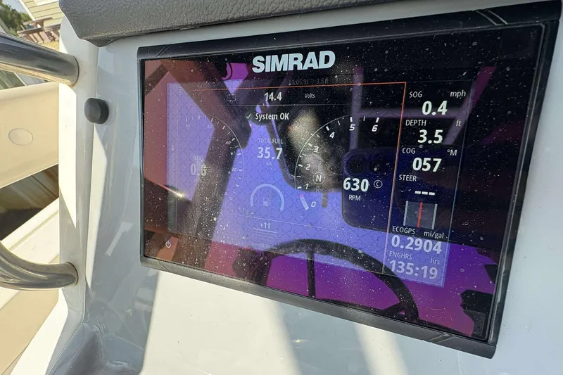 Slide: The Image of Simrad display on 2022 Bayliner Trophy T20CC showing navigation and engine data. - 24