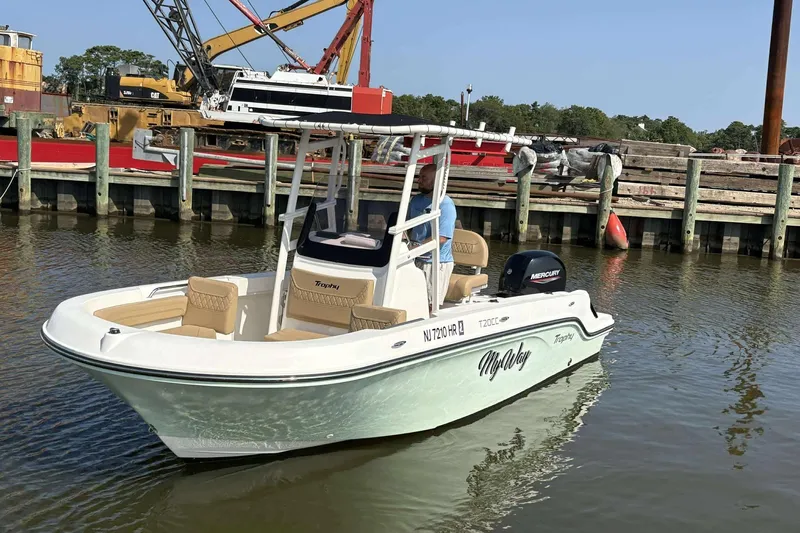 Slide: The Image of 2022 Bayliner Trophy T20CC boat docked in a marina, featuring a Mercury engine. - 3