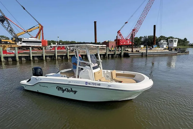 Slide: The Image of 2022 Bayliner Trophy T20CC boat docked near construction cranes. - 4