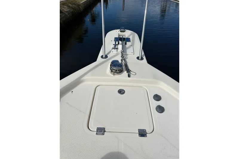 Slide: The Image of 2008 Mainship Pilot 34 boat deck with windows under cloudy sky. - 104