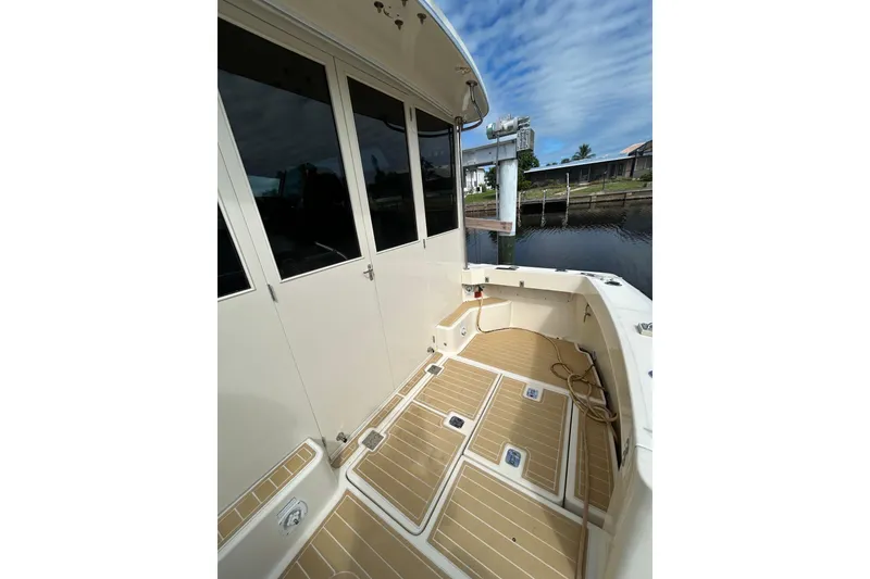 Slide: The Image of Battery compartment of 2008 Mainship Pilot 34 boat, showing wiring and components. - 14