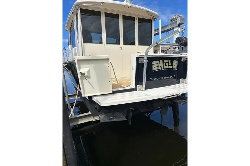 Slide: The Image of 2008 Mainship Pilot 34 boat on calm water under blue sky. - 22