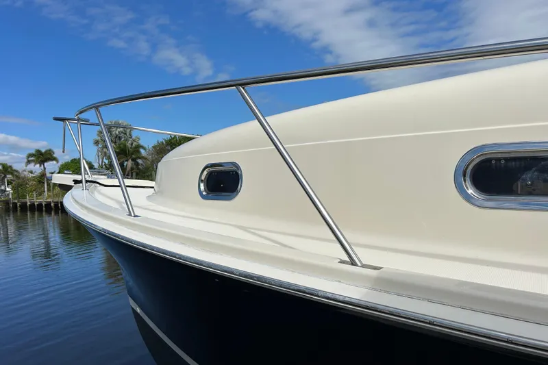 Slide: The Image of 2008 Mainship Pilot 34 boat hull reflecting water, docked at marina. - 23