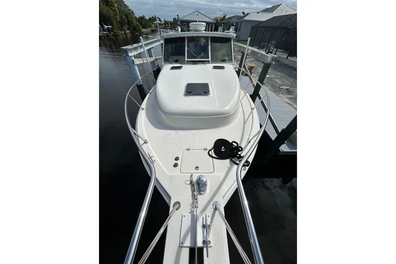 Slide: The Image of 2008 Mainship Pilot 34 boat deck with railing and windows, docked at marina. - 28