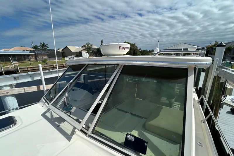Slide: The Image of 2008 Mainship Pilot 34 boat docked, side view showing deck and railing. - 31
