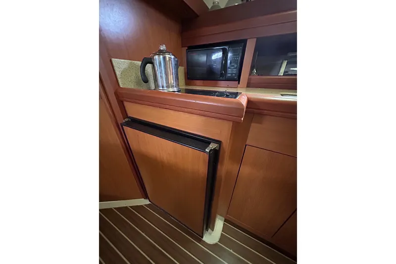 Slide: The Image of 2008 Mainship Pilot 34 galley with sink, microwave, and toaster oven. - 41