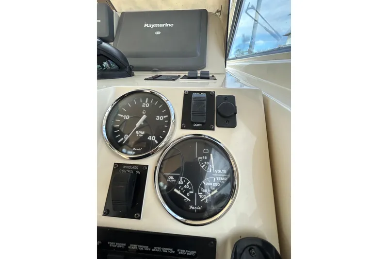 Slide: The Image of 2008 Mainship Pilot 34 dashboard with Raymarine navigation equipment and gauges. - 60