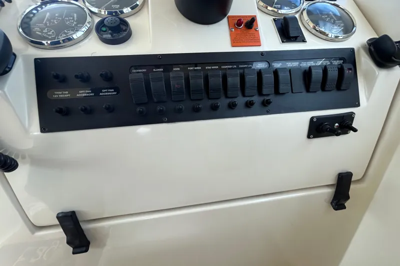 Slide: The Image of 2008 Mainship Pilot 34 dashboard with gauges and Raymarine navigation system. - 61