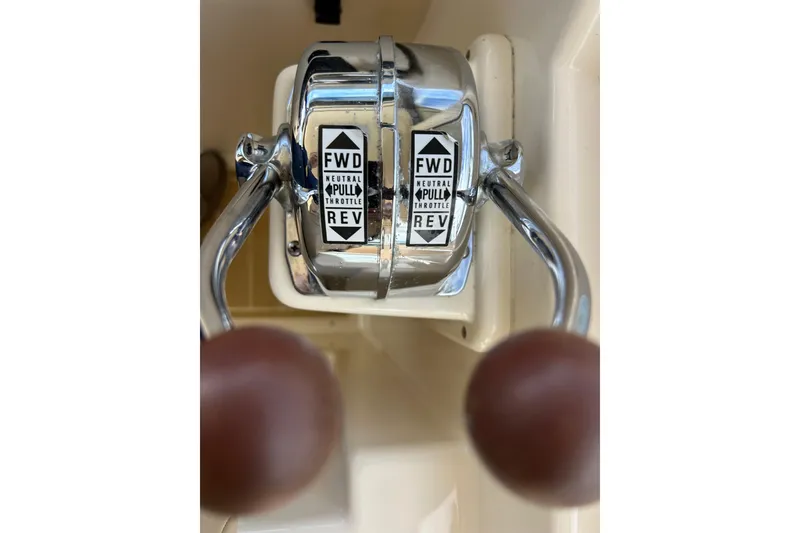 Slide: The Image of Control panel of a 2008 Mainship Pilot 34 boat with switches and gauges. - 62