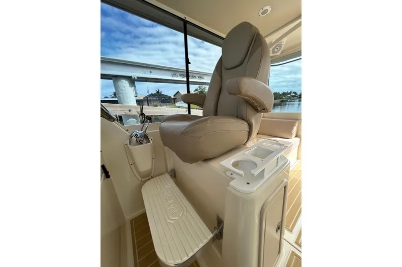 Slide: The Image of 2008 Mainship Pilot 34 helm with leather captain's chair and navigation controls. - 67