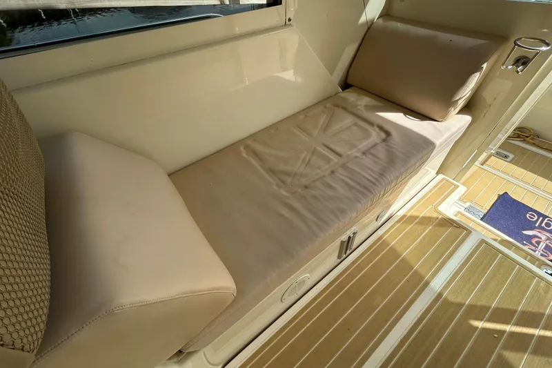 Slide: The Image of 2008 Mainship Pilot 34 interior with beige cushioned seating and wooden flooring. - 71