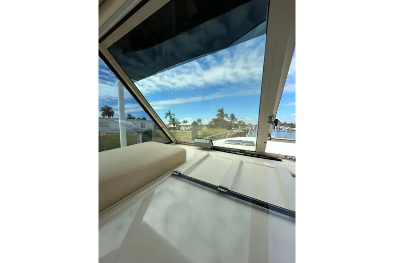 Slide: The Image of Interior view of 2008 Mainship Pilot 34 boat with plush seating and waterfront backdrop. - 73
