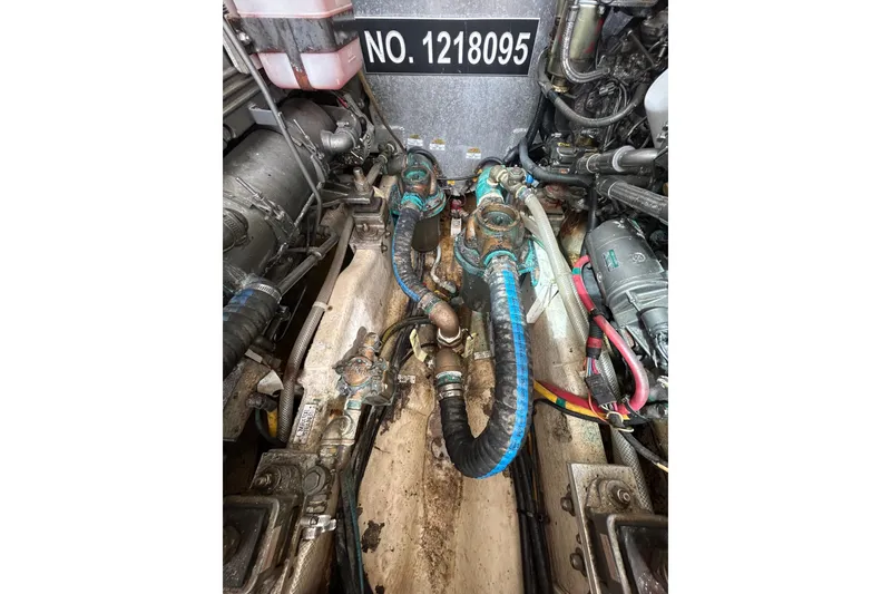 Slide: The Image of Engine room of a 2008 Mainship Pilot 34 boat, showcasing dual engines and components. - 77