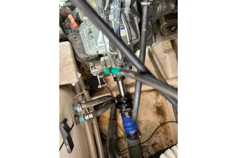 Slide: The Image of Engine room of a 2008 Mainship Pilot 34 boat, showing mechanical components and hoses. - 78
