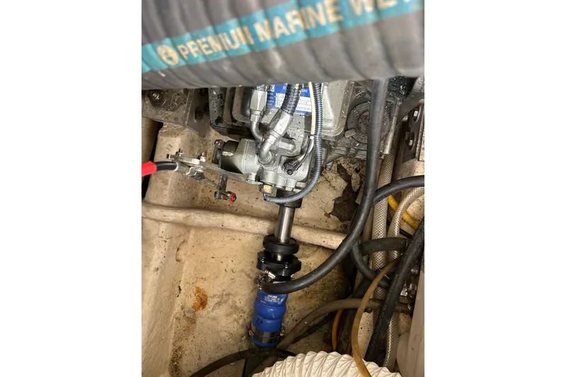 Slide: The Image of Engine compartment of 2008 Mainship Pilot 34 with visible hoses and components. - 79