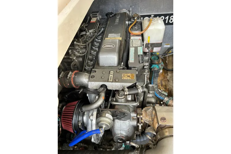 Slide: The Image of Engine compartment of 2008 Mainship Pilot 34 with visible hoses and mechanical components. - 80