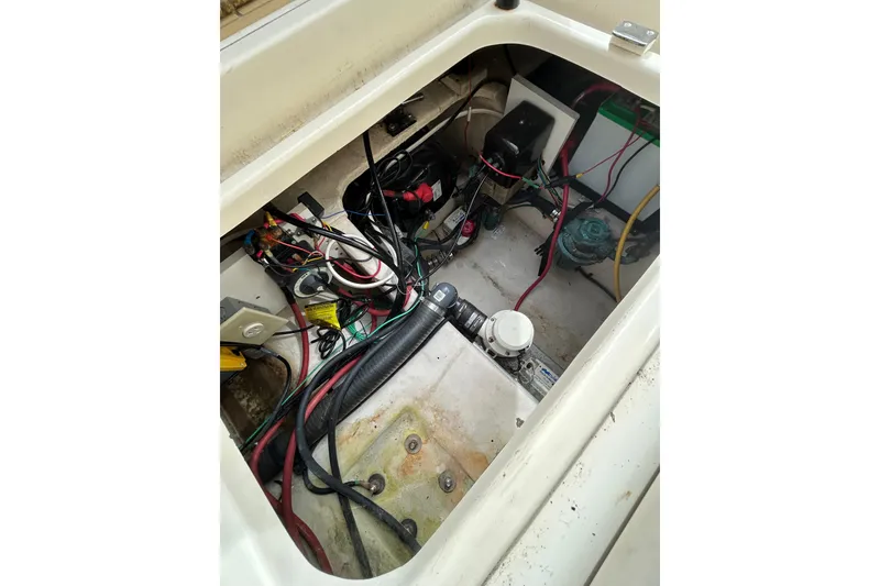 Slide: The Image of Engine compartment of a 2008 Mainship Pilot 34 boat, showing wiring and components. - 93