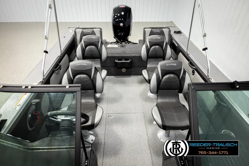 Slide: The Image of 2026 Lund 1875 Tyee boat interior with seating and steering wheel, showcased by Reeder-Trausch Marine. - 22