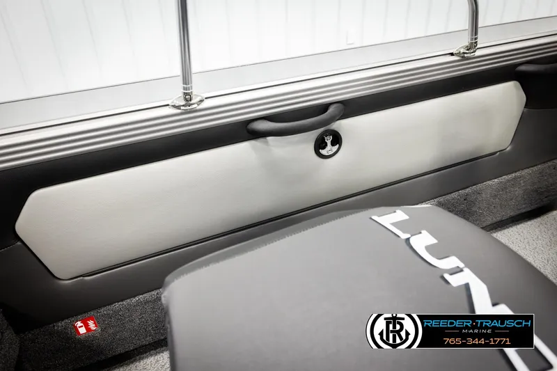 Slide: The Image of 2026 Lund 1875 Tyee boat interior with sleek design and Reeder-Trausch Marine branding. - 25