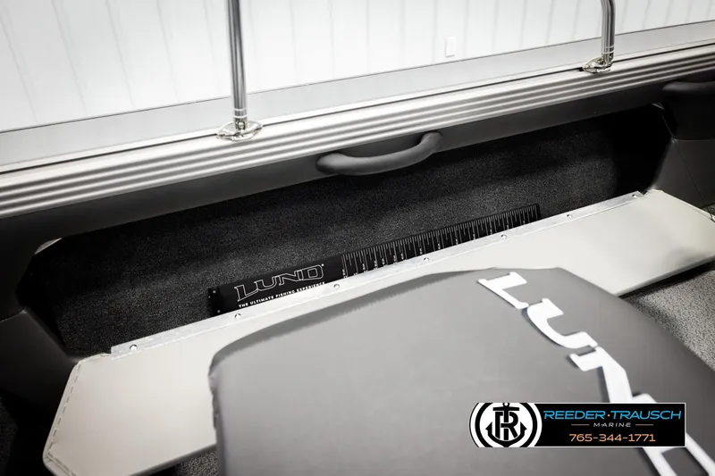 Slide: The Image of 2026 Lund 1875 Tyee boat interior with branded seating and storage area. - 26