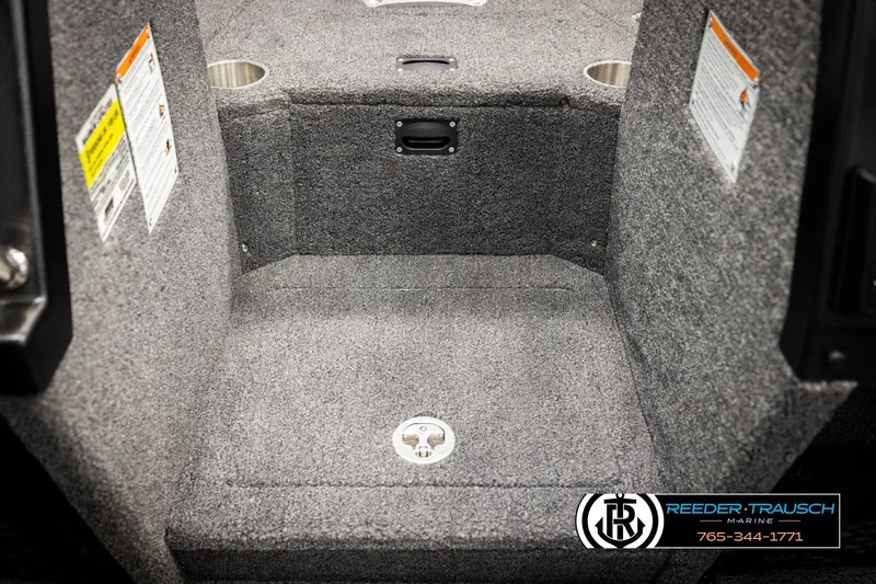 Slide: The Image of 2026 Lund 1875 Tyee boat interior with carpeted flooring and storage compartment. - 27