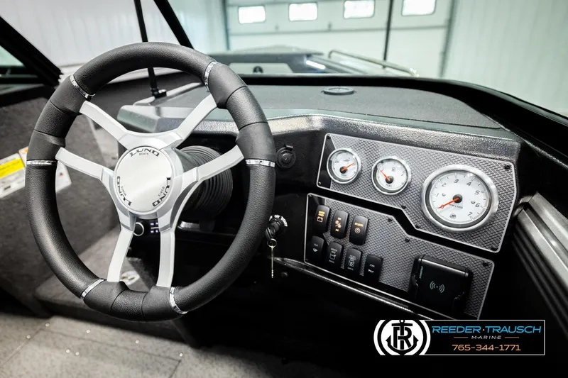 Slide: The Image of 2026 Lund 1875 Tyee boat dashboard with steering wheel and gauges. - 33