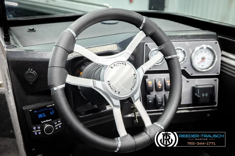 Slide: The Image of 2026 Lund 1875 Tyee boat dashboard with steering wheel and control panel. - 34