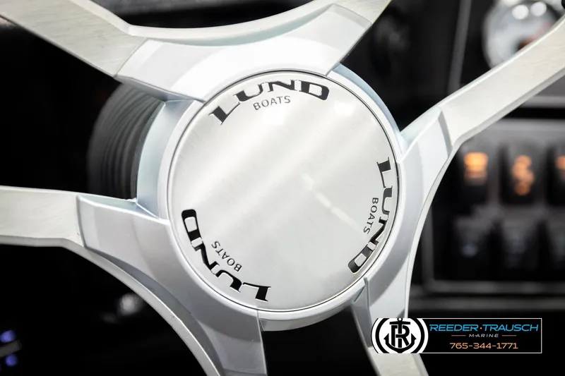 Slide: The Image of Steering wheel of 2026 Lund 1875 Tyee boat, featuring sleek metallic design. - 36