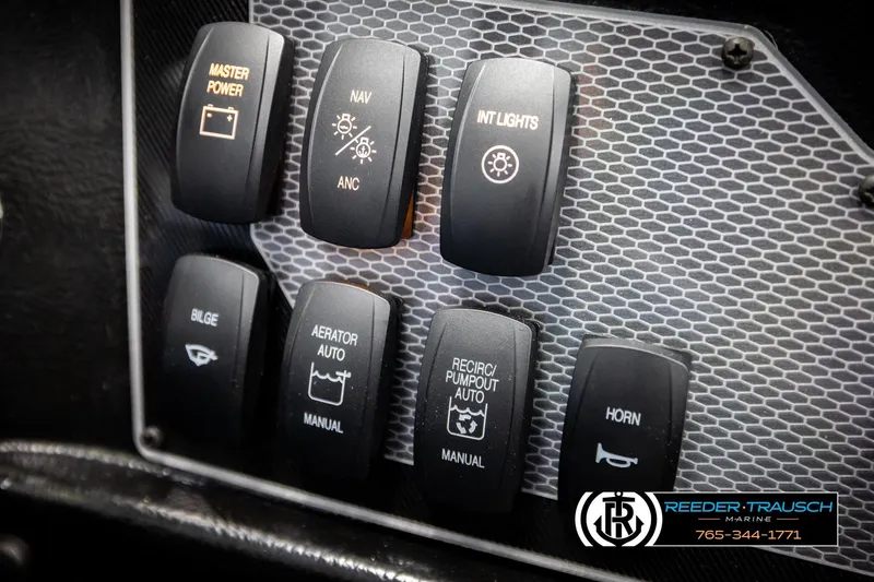 Slide: The Image of Control panel of 2026 Lund 1875 Tyee boat with various switches and labels. - 38