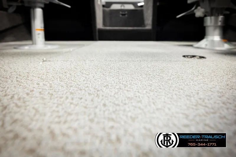 Slide: The Image of 2026 Lund 1875 Tyee boat interior with textured flooring and pedestal mounts. - 44