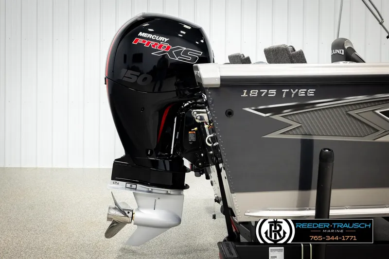 Slide: The Image of 2026 Lund 1875 Tyee boat with Mercury Pro XS 150 engine, displayed indoors. - 49