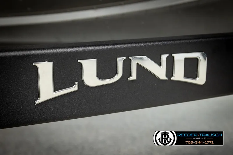 Slide: The Image of Close-up of 2026 Lund 1875 Tyee logo on a boat, featuring sleek metallic lettering. - 54