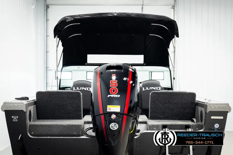 Slide: The Image of 2026 Lund 1875 Tyee boat with 50 Pro motor, displayed indoors. - 6