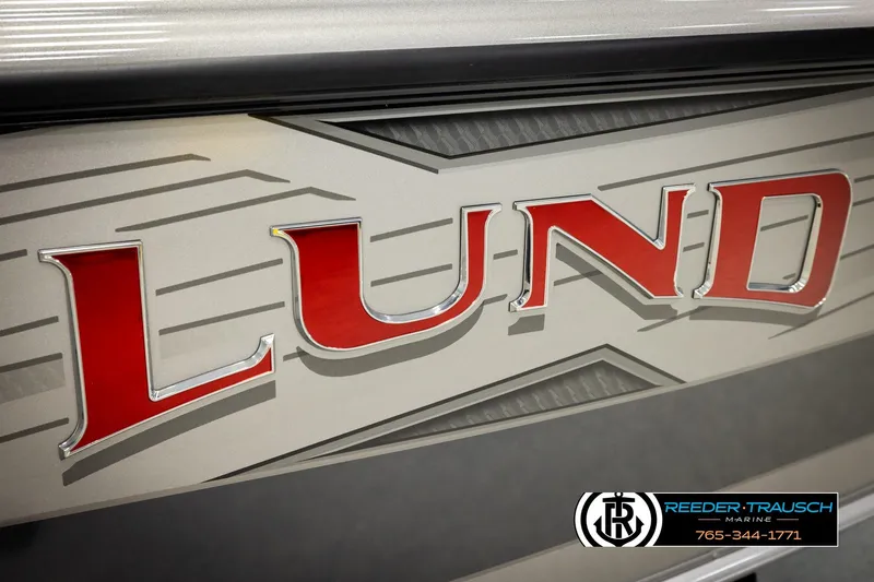 Slide: The Image of Close-up of 2026 Lund 1875 Tyee boat logo with dealership contact information. - 62