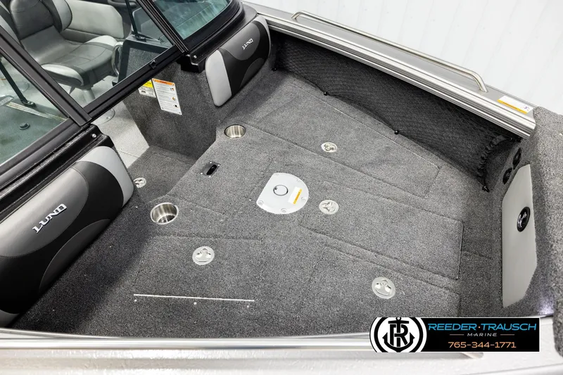 Slide: The Image of 2026 Lund 1875 Tyee boat interior with gray carpet and seating, featuring cup holders. - 8