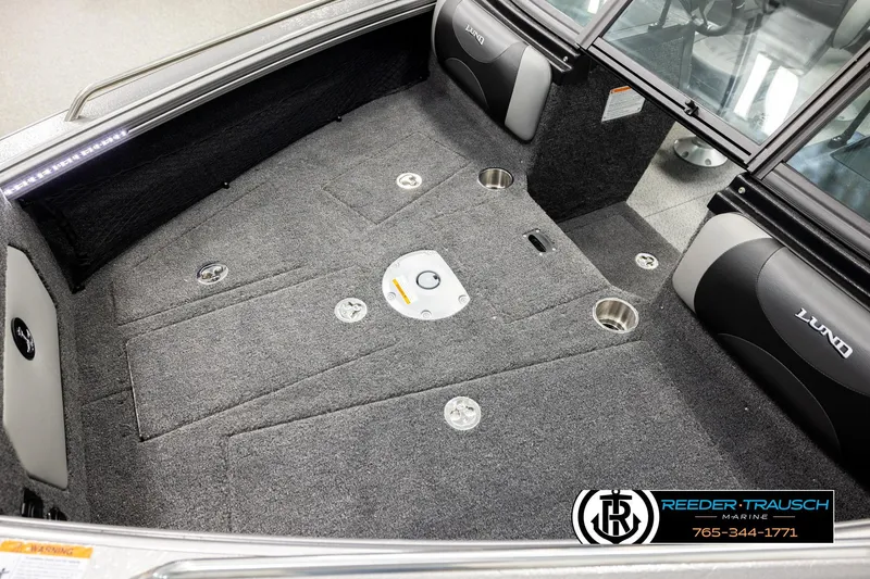 Slide: The Image of 2026 Lund 1875 Tyee boat interior with carpeted deck and seating. - 9