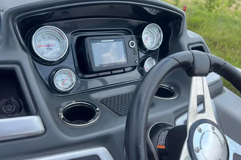 Slide: The Image of Dashboard of 2019 Ranger Reata 200C boat with gauges and steering wheel. - 16
