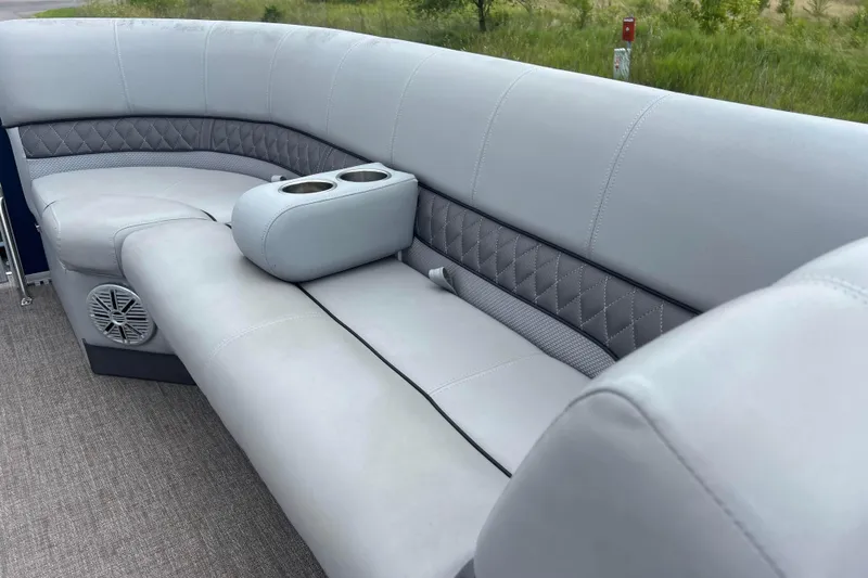 Slide: The Image of 2019 Ranger Reata 200C boat interior with gray cushioned seating and cup holders. - 17