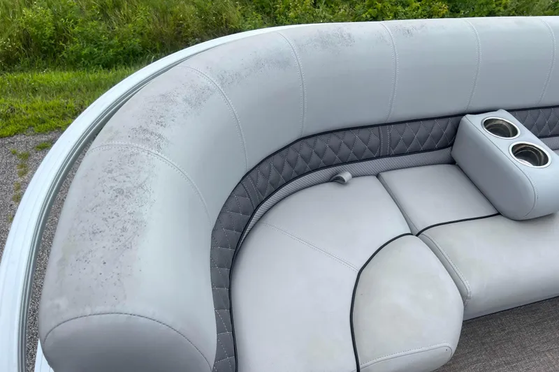 Slide: The Image of 2019 Ranger Reata 200C boat seating with cup holders, showing light wear and outdoor setting. - 19