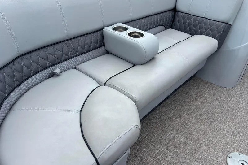 Slide: The Image of 2019 Ranger Reata 200C boat interior with cushioned seating and cup holders. - 22