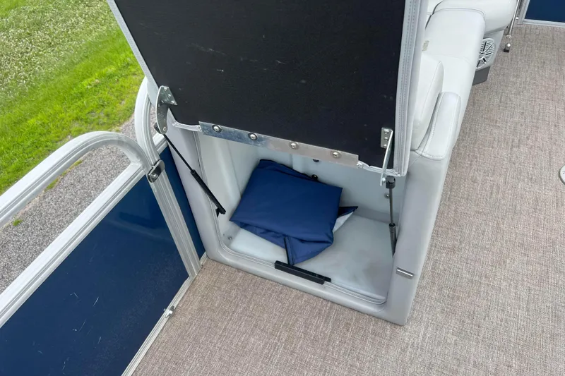 Slide: The Image of 2019 Ranger Reata 200C boat storage compartment with blue cushion inside. - 24