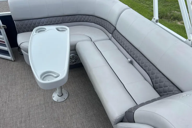 Slide: The Image of 2019 Ranger Reata 200C boat interior with gray seating and table. - 25