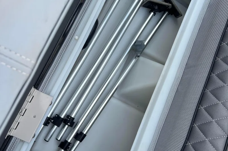 Slide: The Image of Storage compartment in 2019 Ranger Reata 200C boat with metal rods and quilted lining. - 26