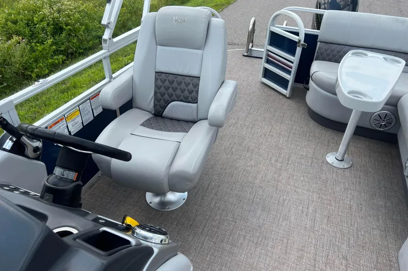 Slide: The Image of 2019 Ranger Reata 200C boat interior with plush seating and steering console. - 27
