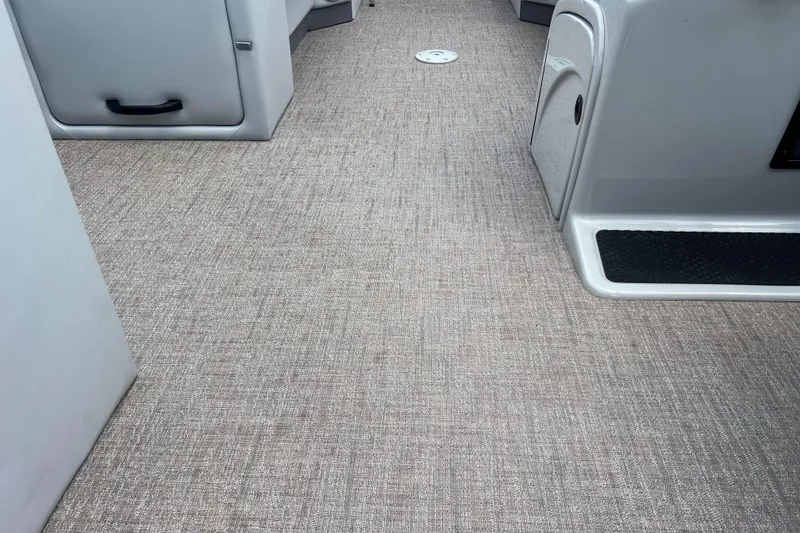 Slide: The Image of Interior of a 2019 Ranger Reata 200C boat with gray flooring and storage compartments. - 31