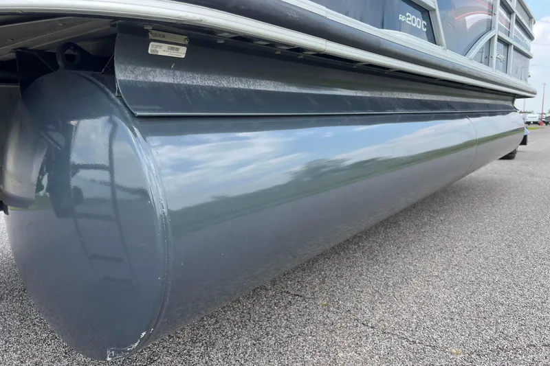 Slide: The Image of 2019 Ranger Reata 200C pontoon boat on asphalt surface, close-up view. - 34