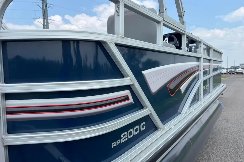 Slide: The Image of 2019 Ranger Reata 200C pontoon boat with sleek blue and silver design. - 35